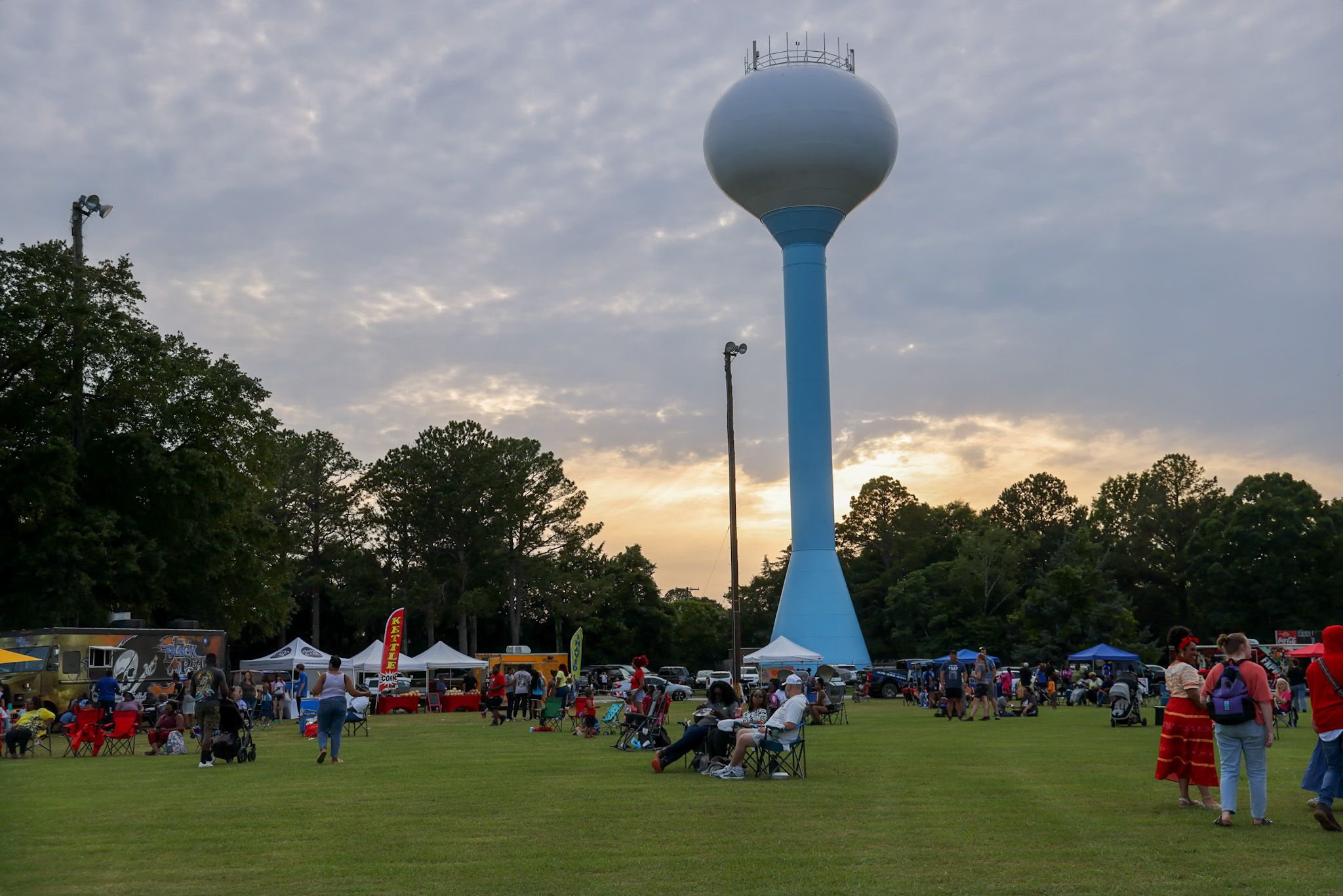 Warner Robins community gathering beneath the city water tower at sunset