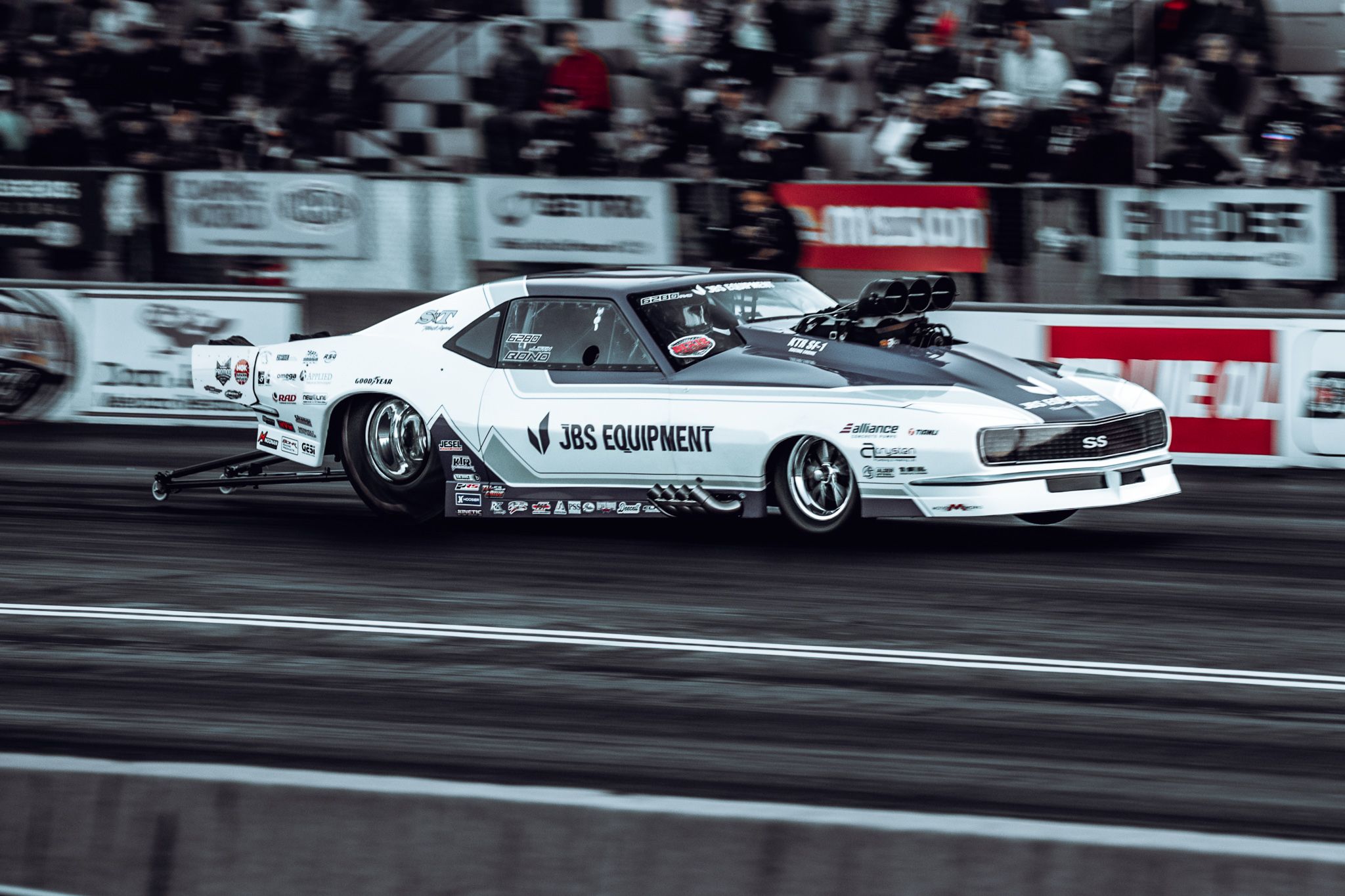 Panning photograph of an NHRA drag racing car at speed